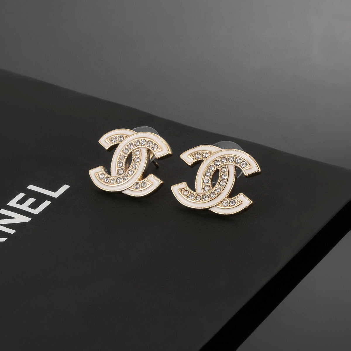 Martin Graham stud earrings in polished metal-tone – styled product view