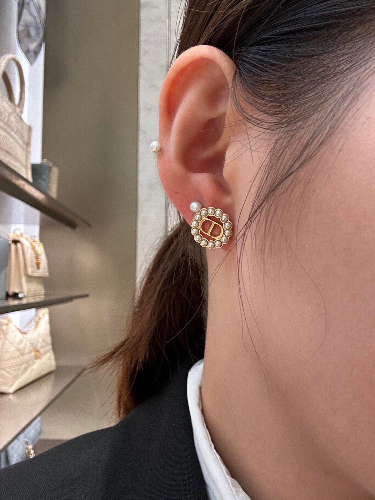 Martin Graham stud earrings in polished metal-tone – close-up detail