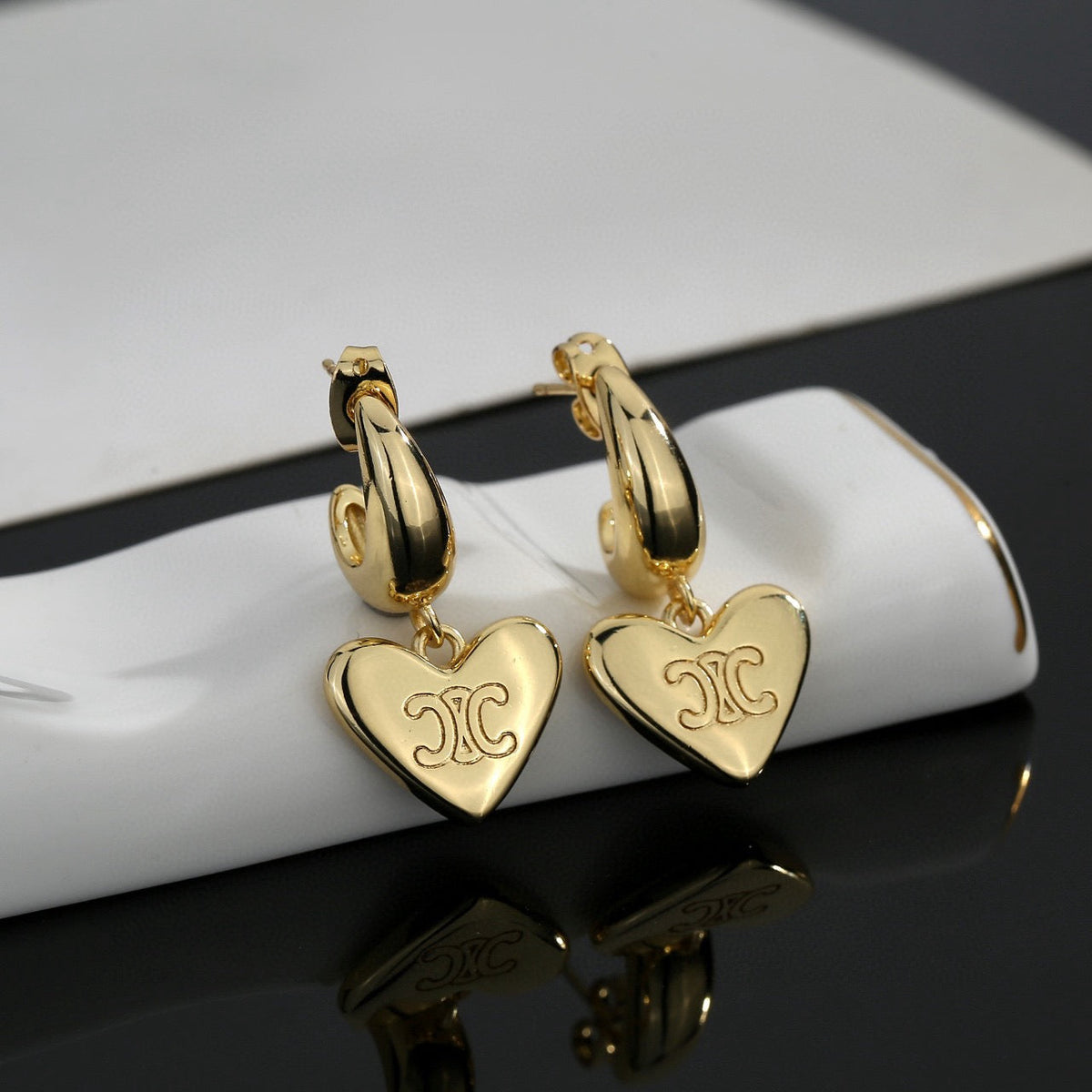Martin Graham stud earrings in polished metal-tone