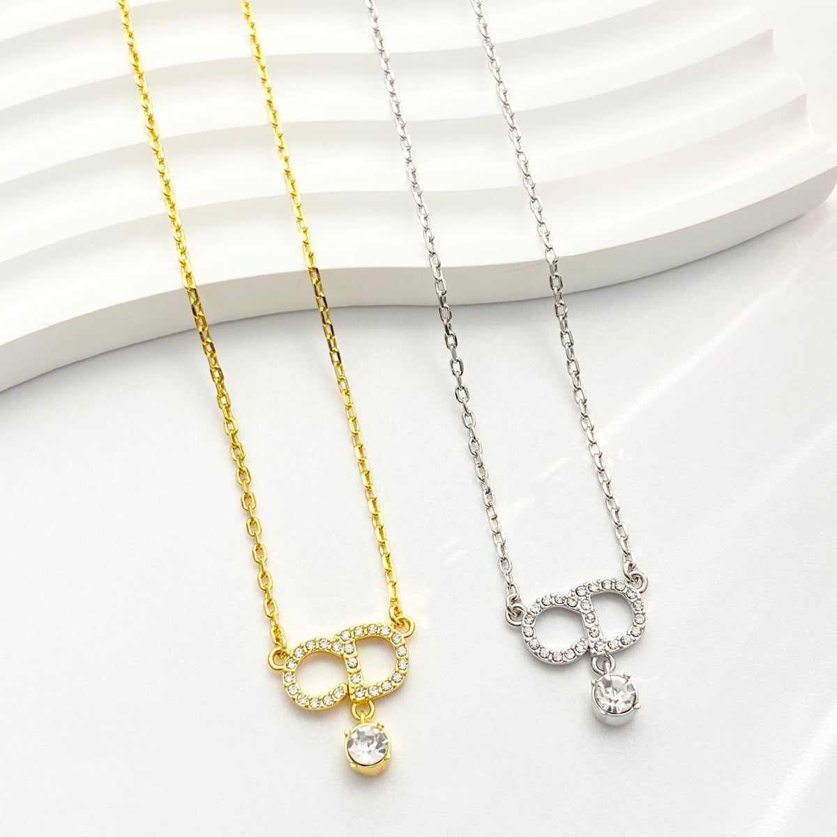 Martin Graham pendant necklace in polished metal-tone – front view