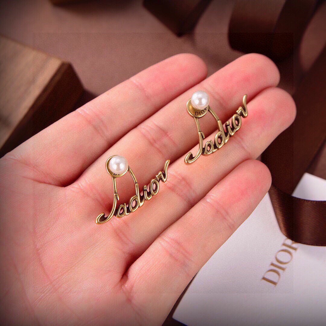 Martin Graham stud earrings in polished metal-tone – detail view