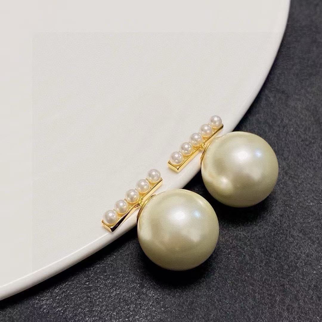 Martin Graham stud earrings in polished metal-tone – detail view