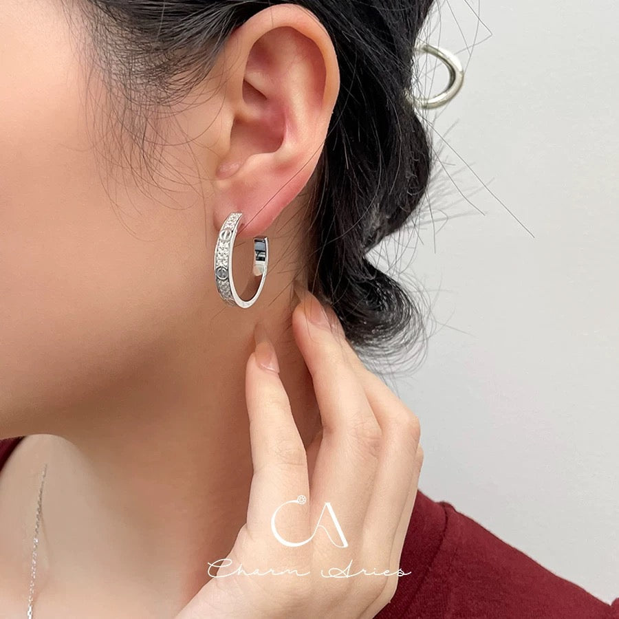 Martin Graham stud earrings in polished metal-tone – side detail