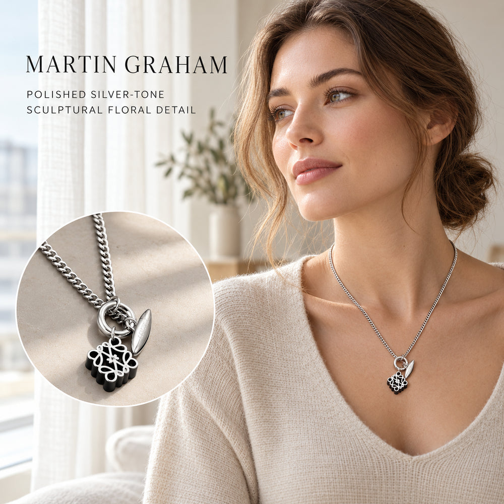 Martin Graham silver-tone floral pendant necklace worn by a woman in soft window light