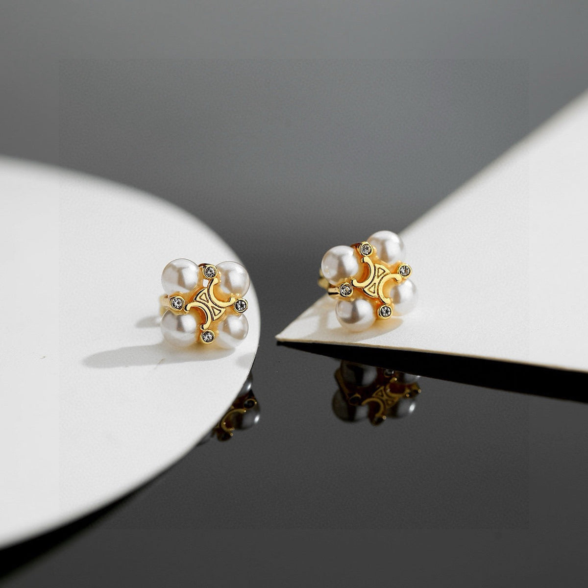 Martin Graham stud earrings in polished metal-tone – front view