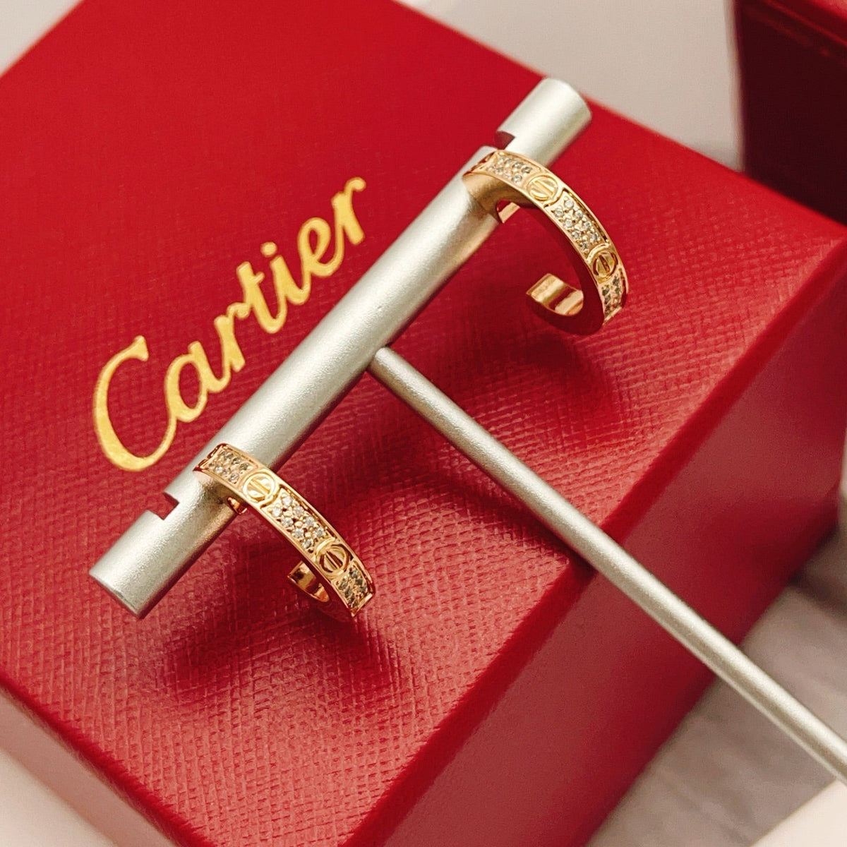 Martin Graham stud earrings in polished metal-tone – front view