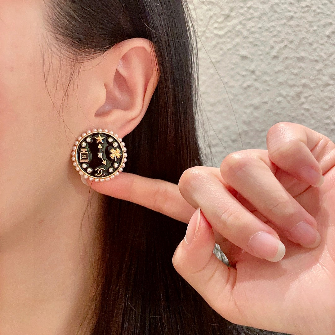 Martin Graham stud earrings in polished metal-tone – front product view