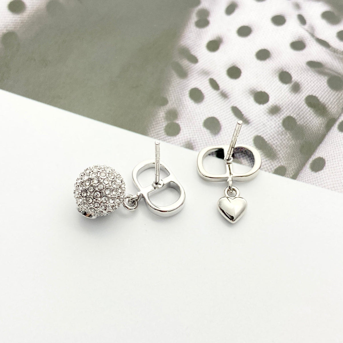 Martin Graham stud earrings in polished metal-tone – front view