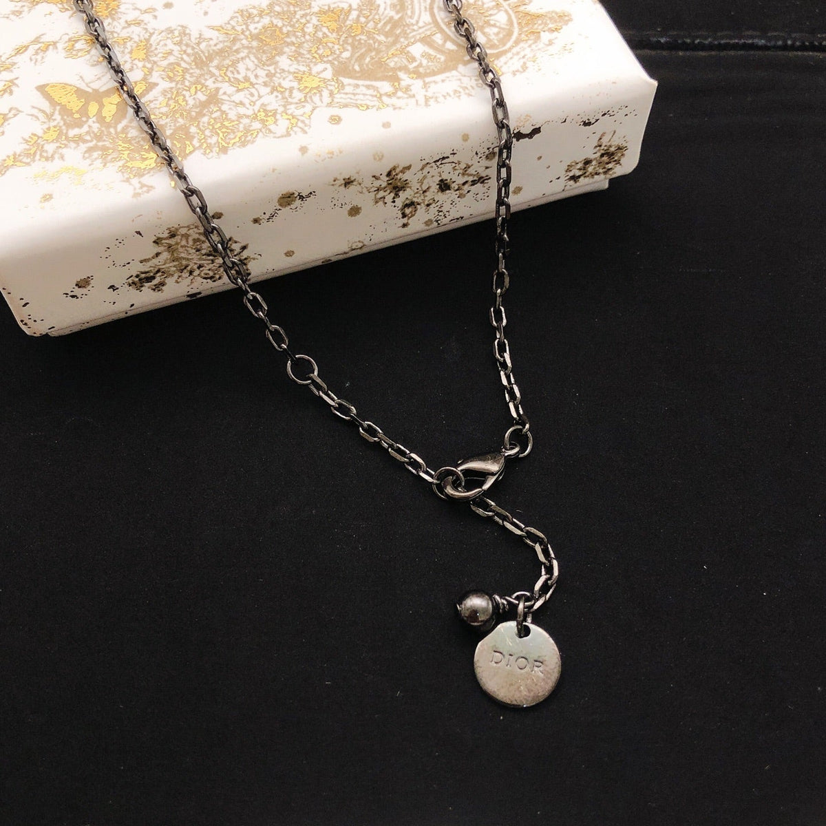 Martin Graham pendant necklace in polished metal-tone – front view
