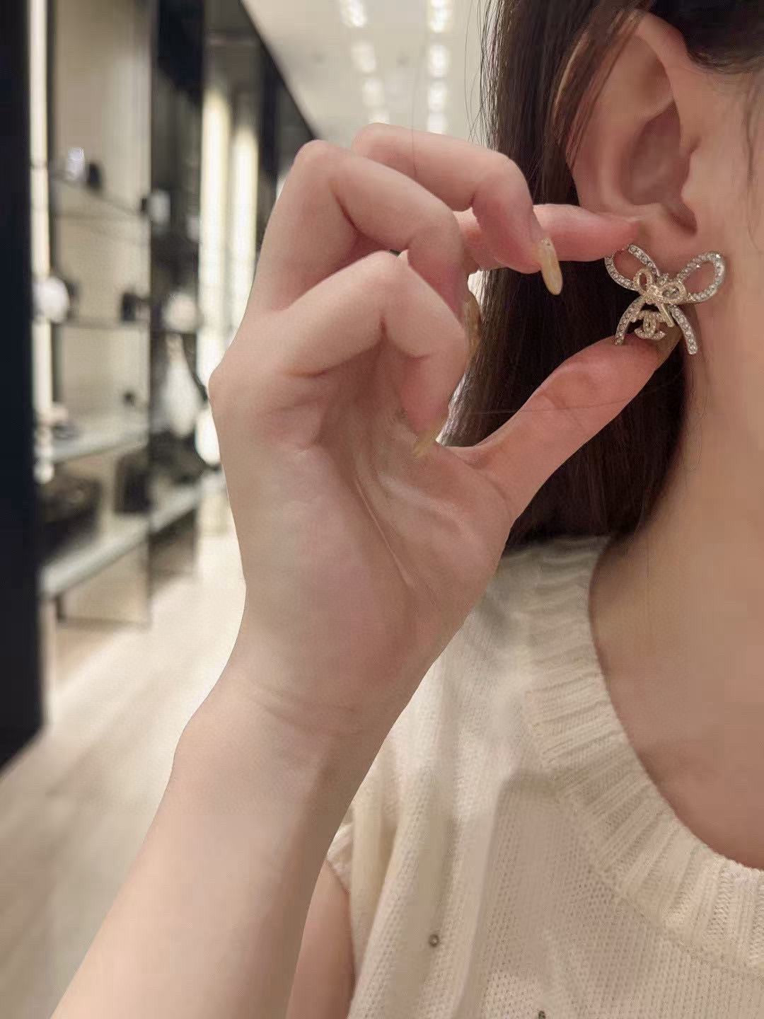 Martin Graham stud earrings in polished metal-tone – front product view