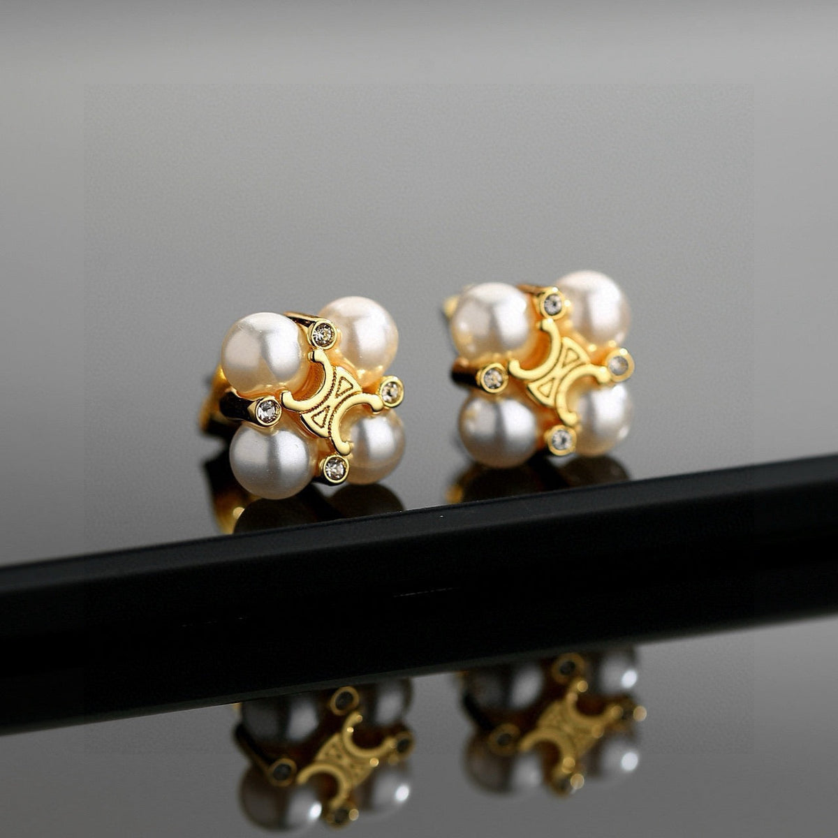 Martin Graham stud earrings in polished metal-tone – front view