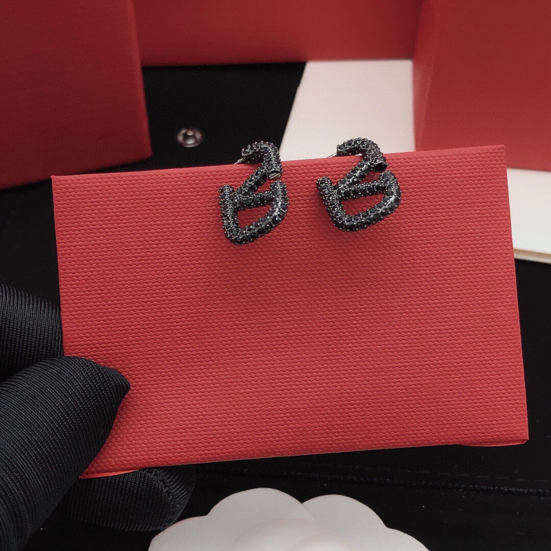 Martin Graham stud earrings in polished metal-tone – detail view