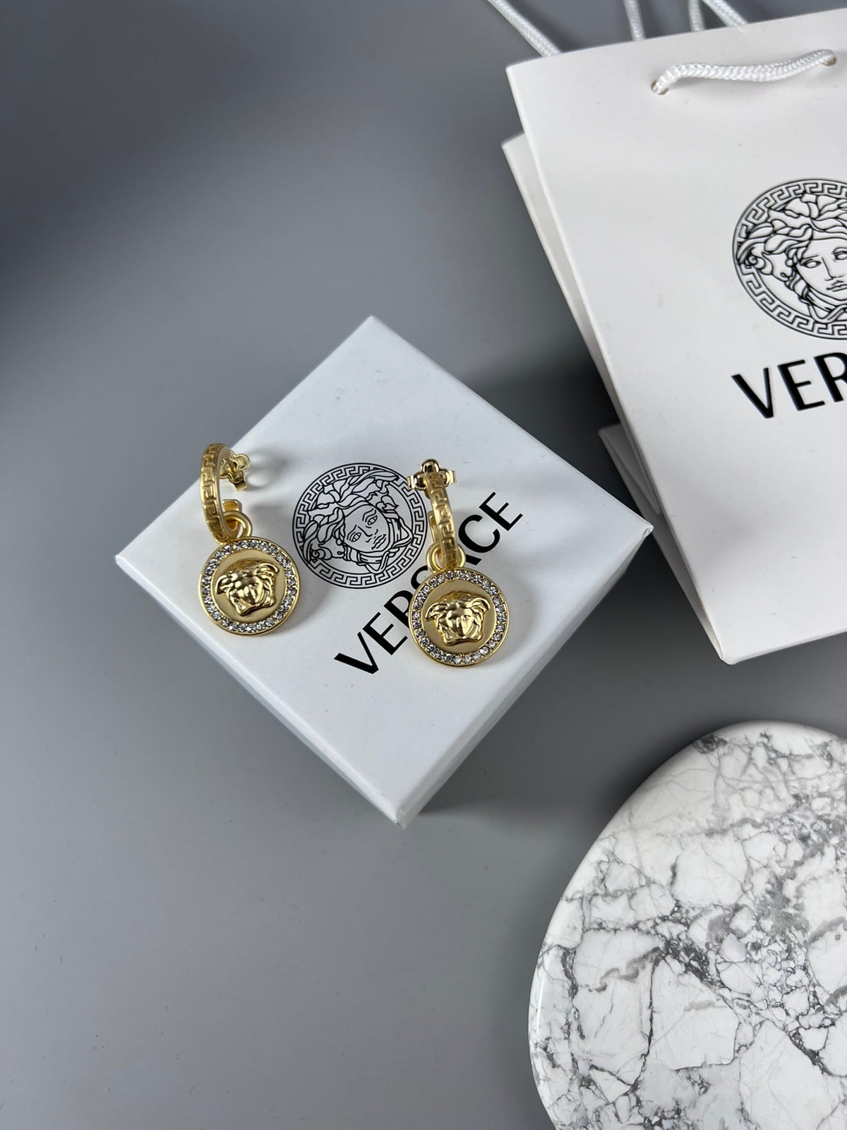 Martin Graham stud earrings in polished metal-tone – detail view