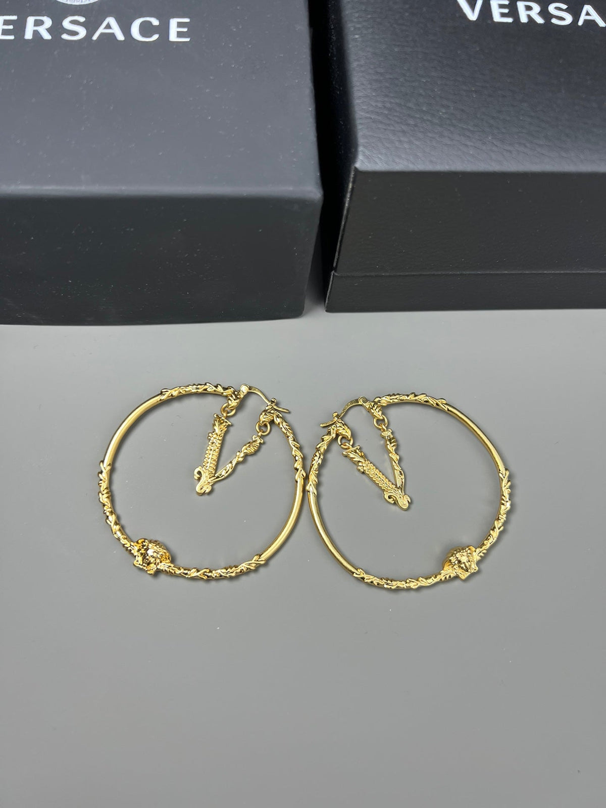Martin Graham stud earrings in polished metal-tone – detail view