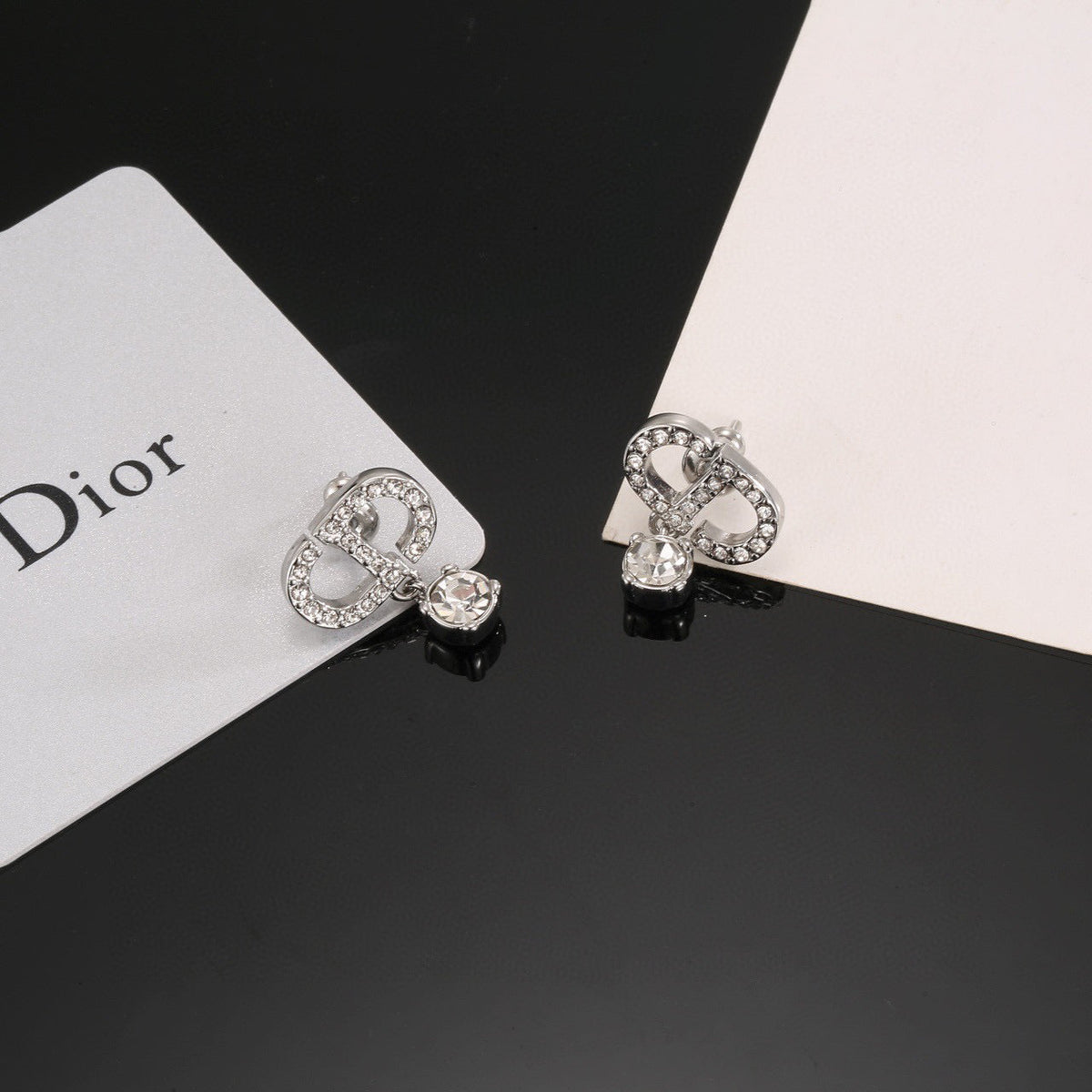 Martin Graham stud earrings in polished metal-tone – detail view