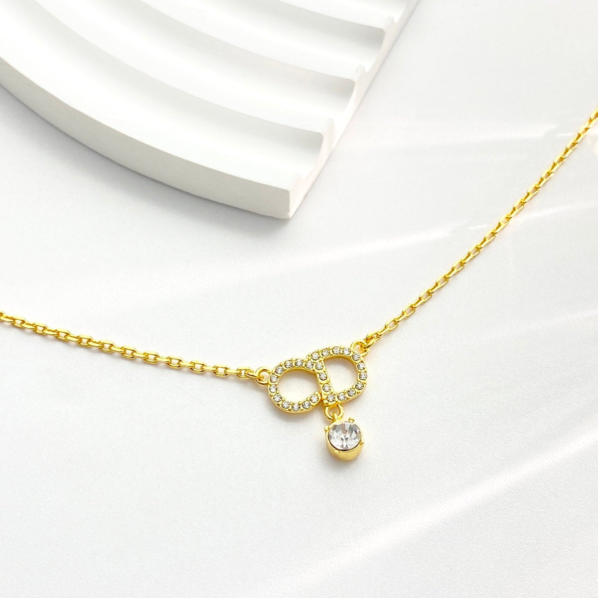 Martin Graham pendant necklace in polished metal-tone – detail view