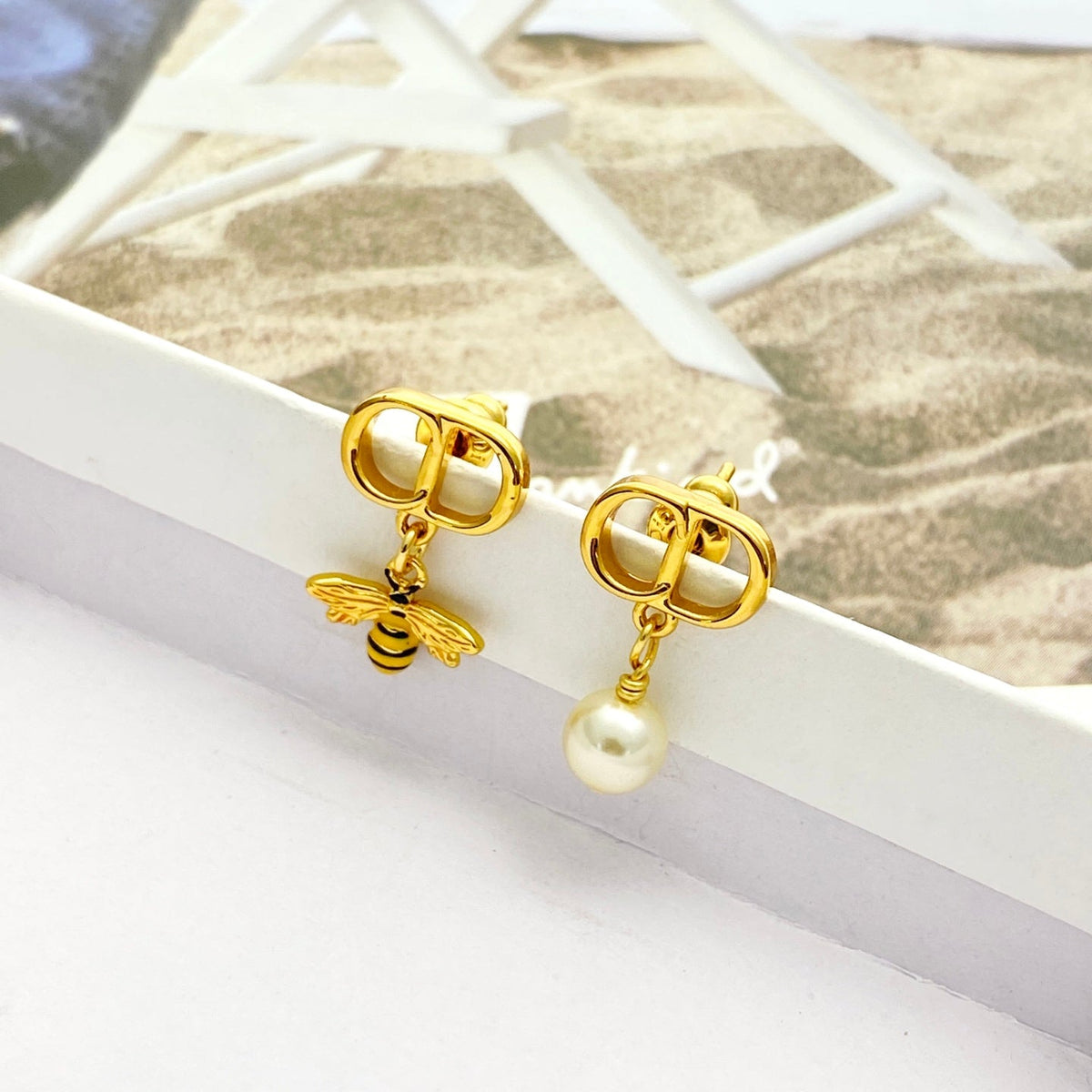 Martin Graham stud earrings in polished metal-tone – detail view
