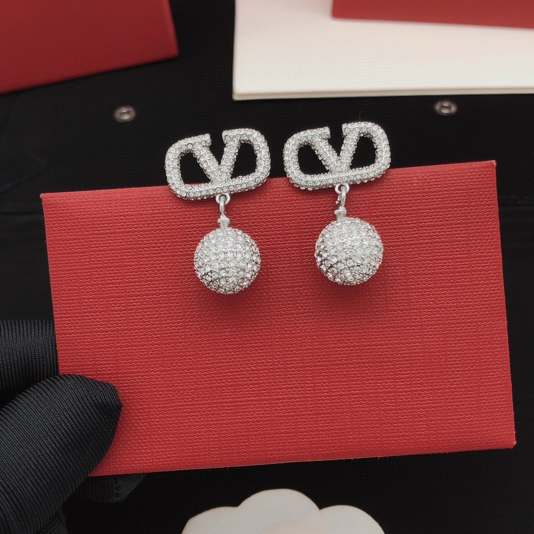 Martin Graham stud earrings in polished metal-tone – detail view