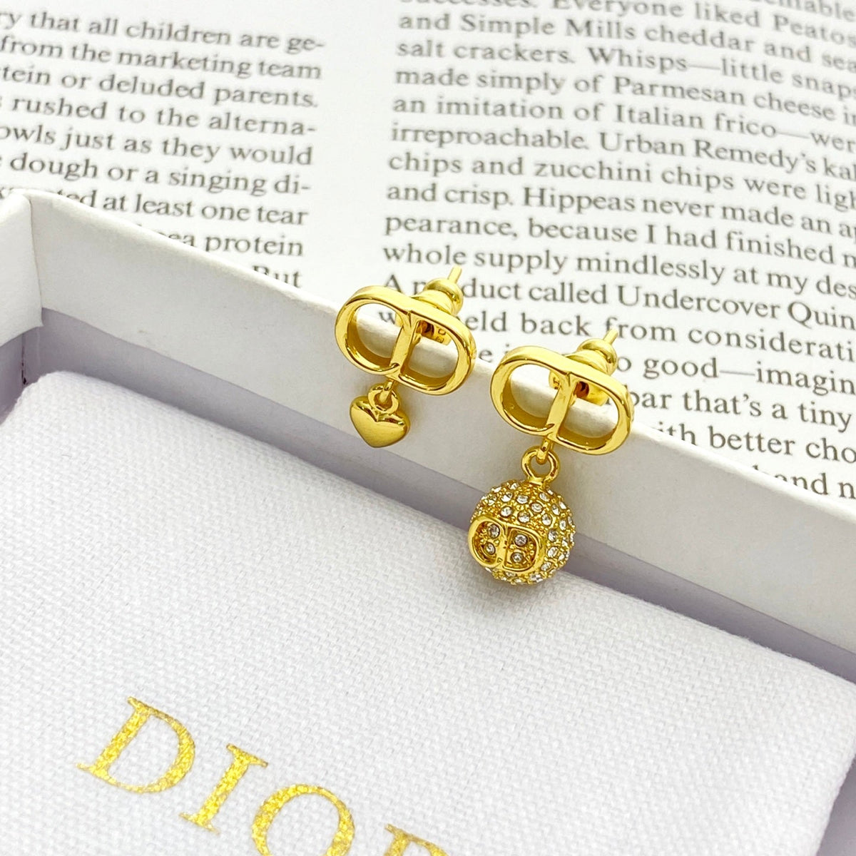 Martin Graham stud earrings in polished metal-tone – detail view