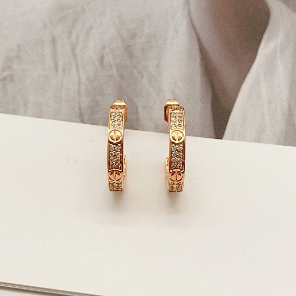 Martin Graham stud earrings in polished metal-tone – detail view