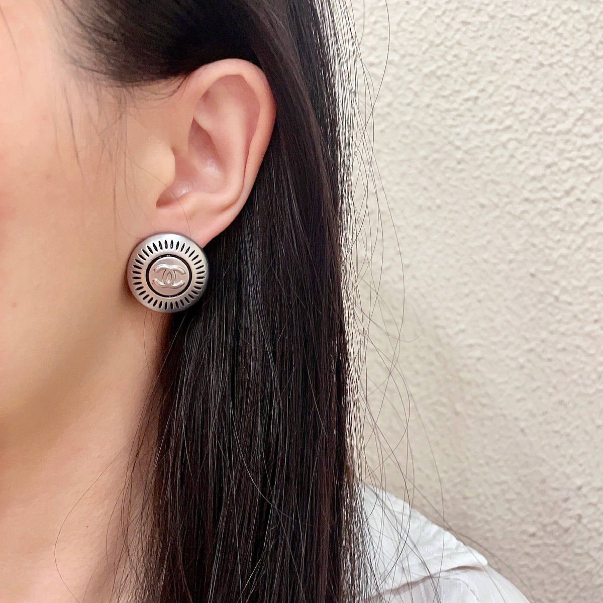 Martin Graham stud earrings in polished metal-tone – detail view