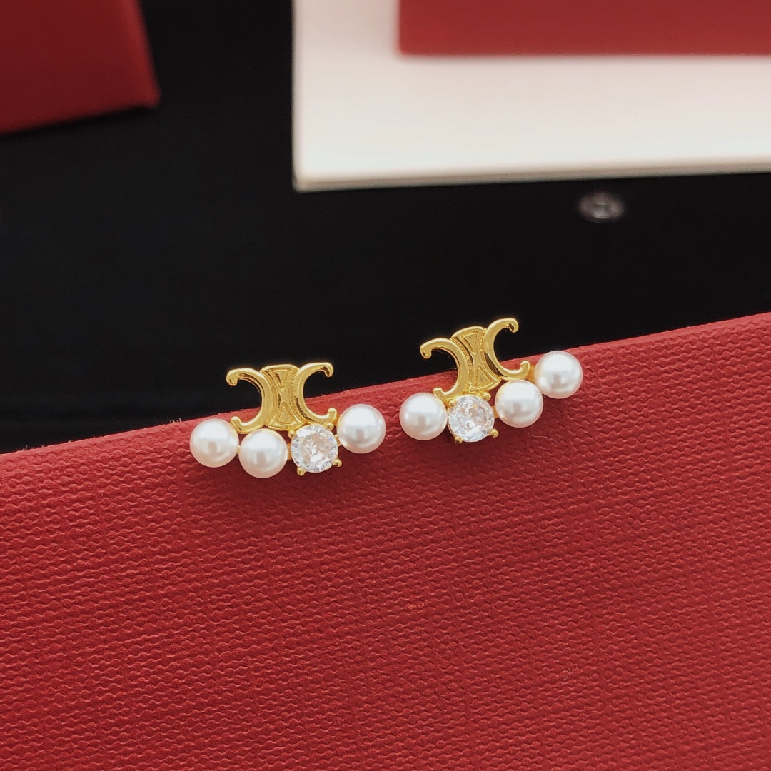 Martin Graham stud earrings in polished metal-tone – detail view