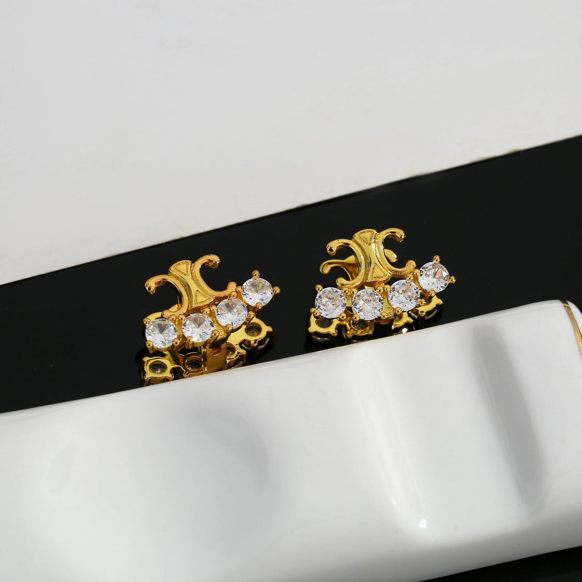 Martin Graham stud earrings in polished metal-tone – detail view