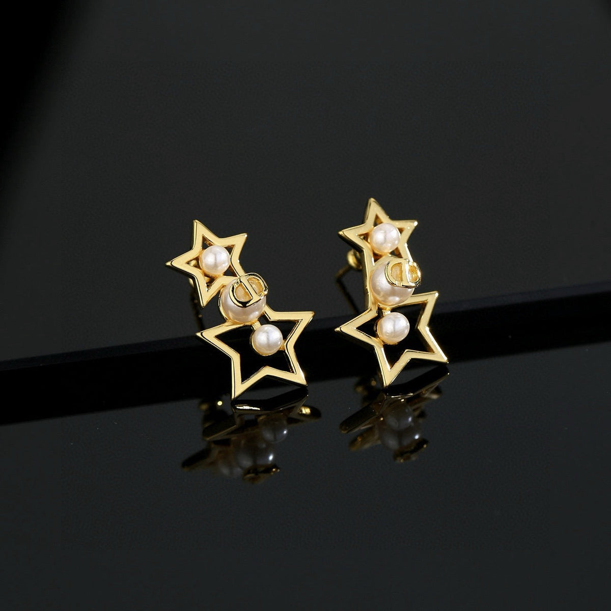 Martin Graham stud earrings in polished metal-tone – detail view