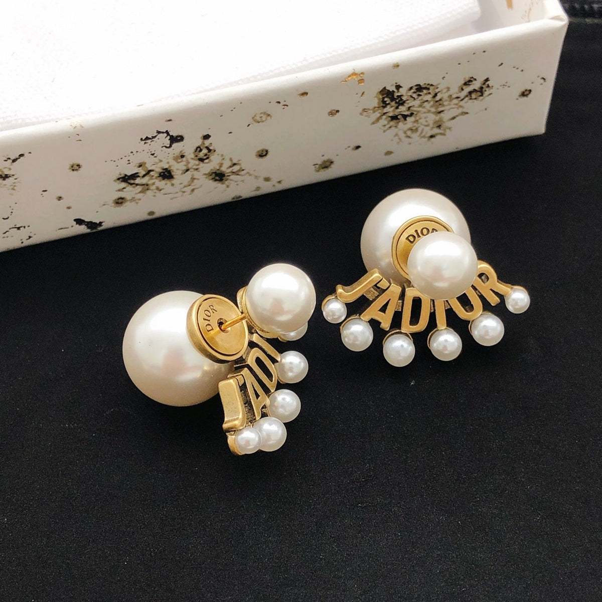 Martin Graham stud earrings in polished metal-tone – detail view