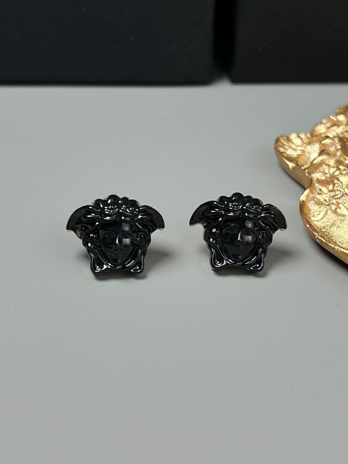 Martin Graham stud earrings in polished metal-tone – detail view