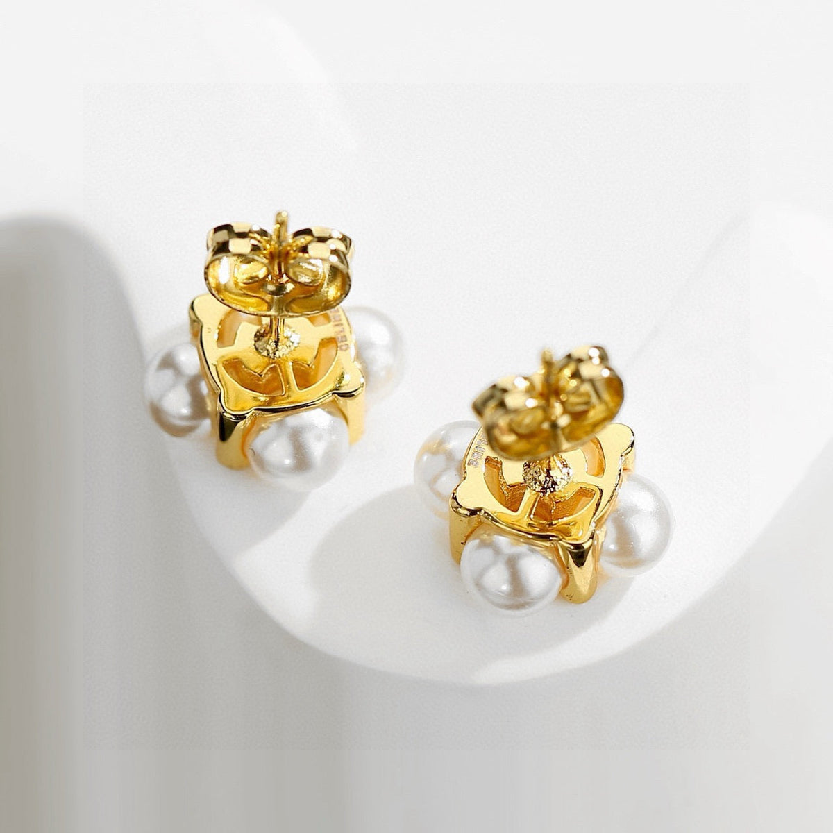 Martin Graham stud earrings in polished metal-tone – detail view