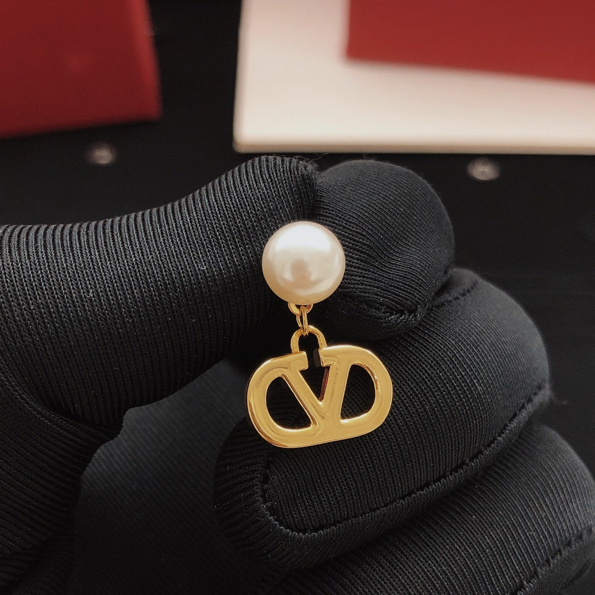 Martin Graham stud earrings in polished metal-tone – detail view
