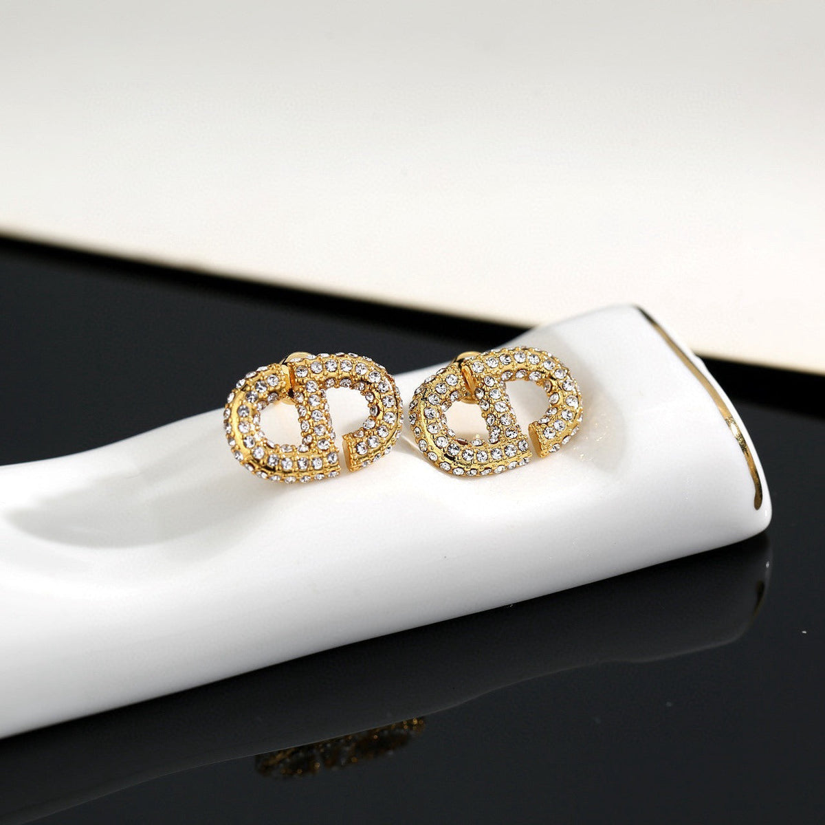Martin Graham stud earrings in polished metal-tone – detail view