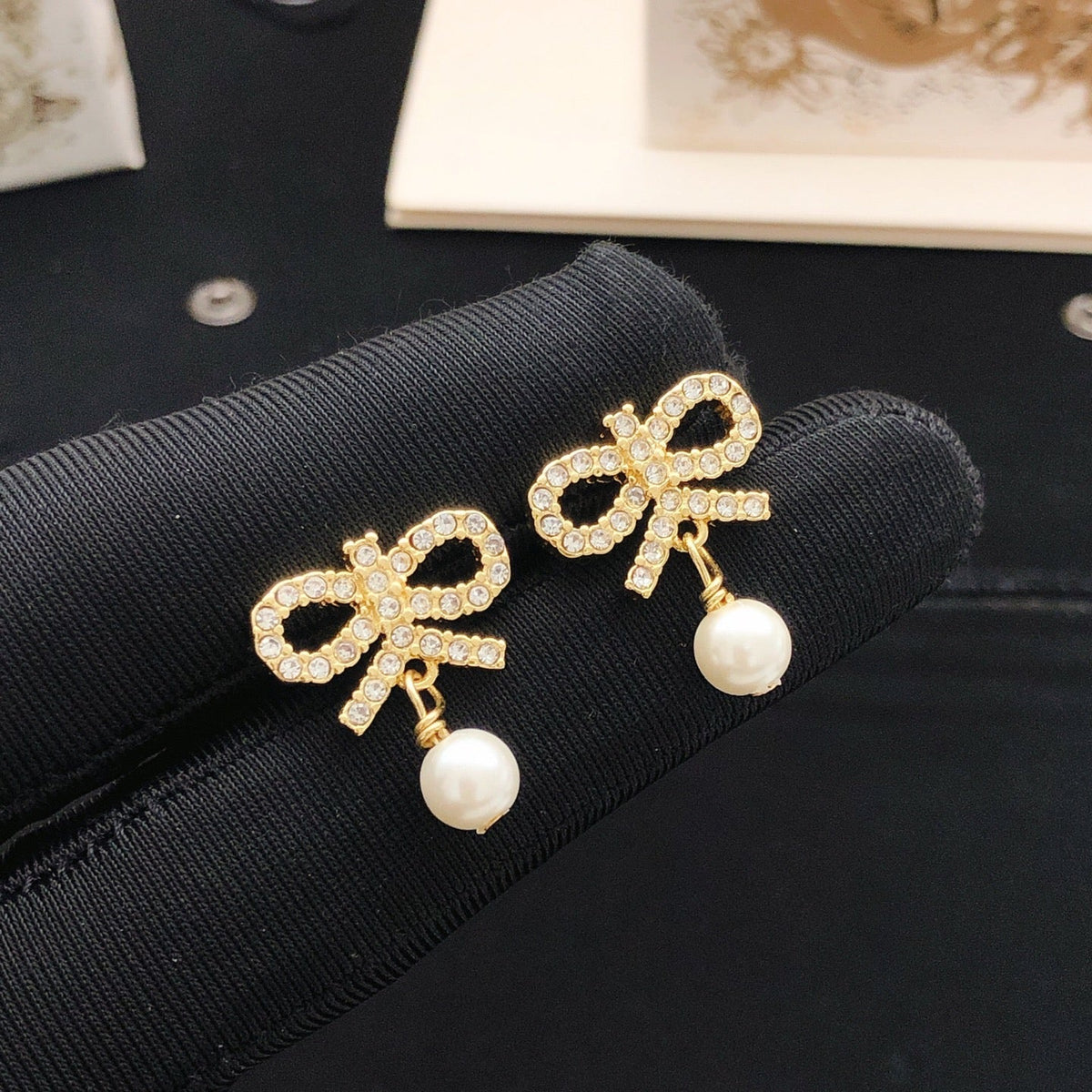 Martin Graham stud earrings in polished metal-tone – detail view