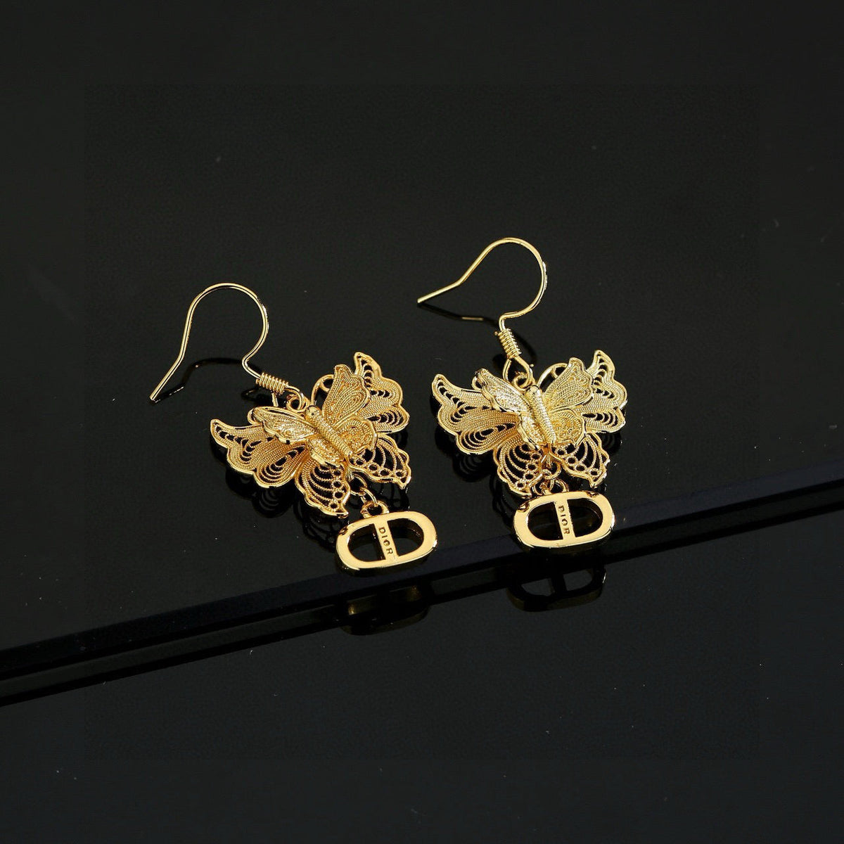 Martin Graham stud earrings in polished metal-tone – detail view