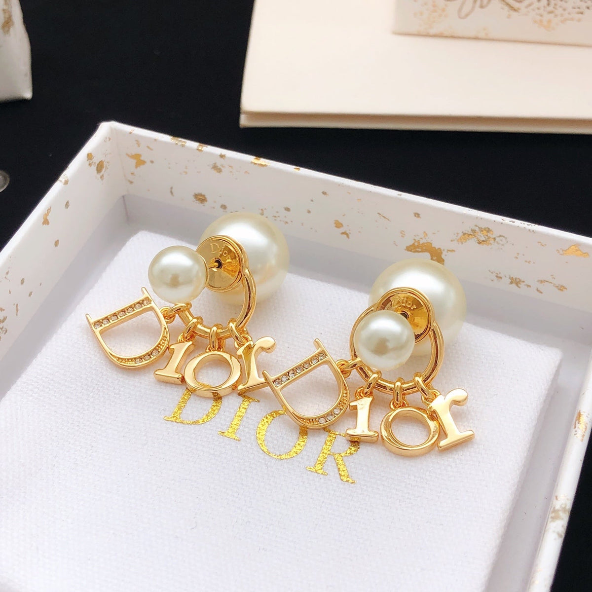 Martin Graham stud earrings in polished metal-tone – detail view