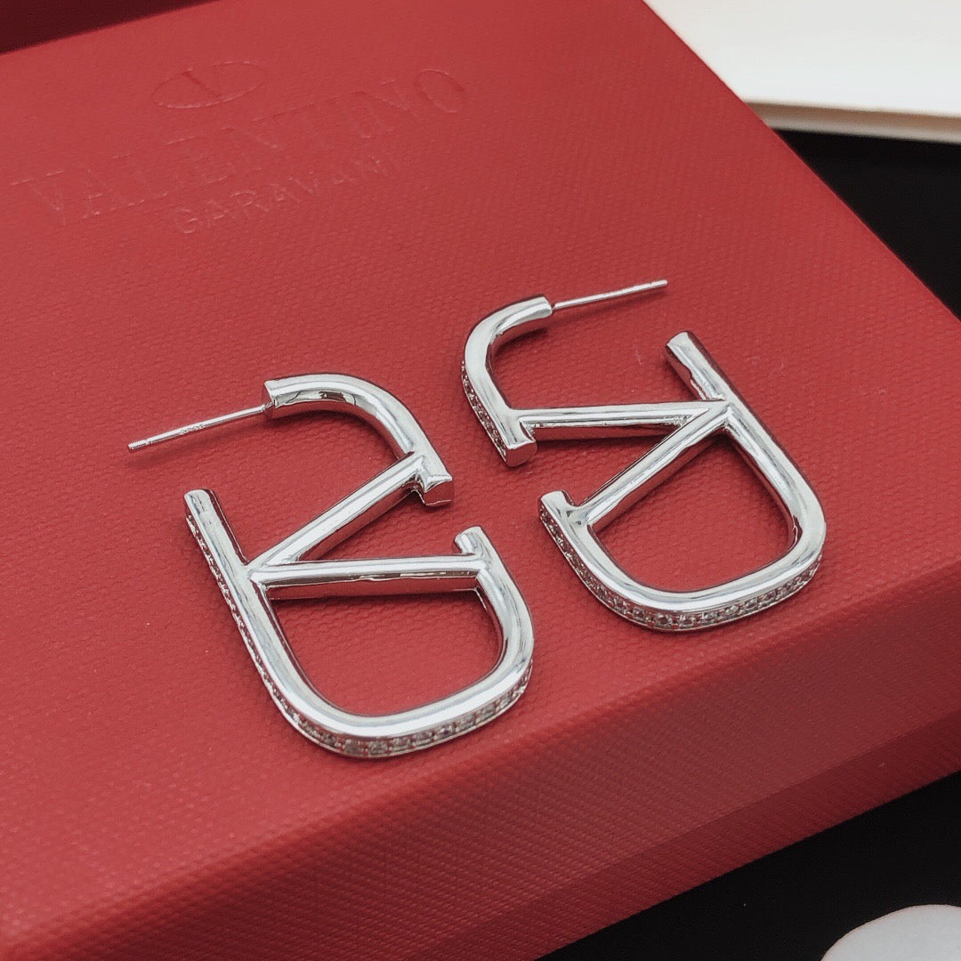 Martin Graham stud earrings in polished metal-tone – detail view