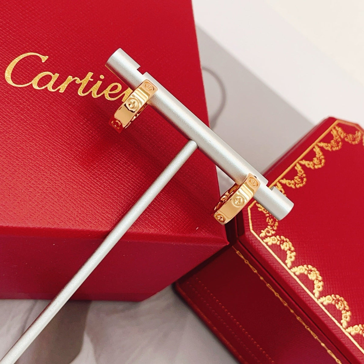 Martin Graham stud earrings in polished metal-tone – detail view