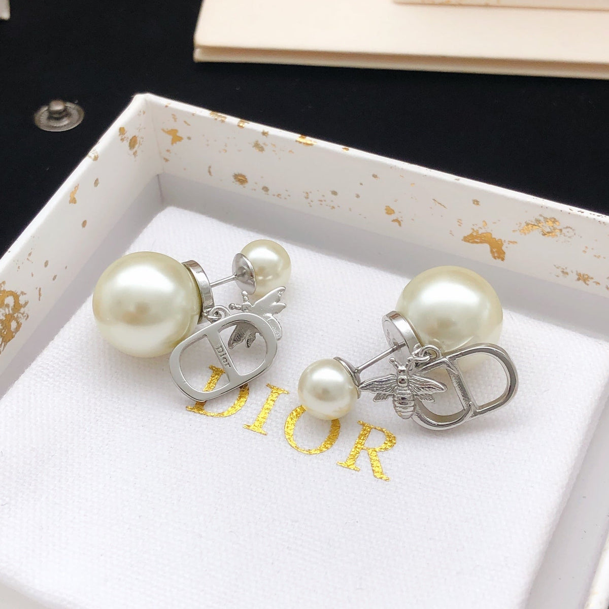 Martin Graham stud earrings in polished metal-tone – detail view