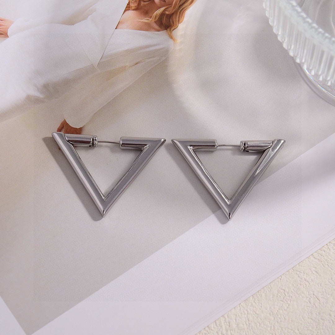 Martin Graham stud earrings in polished metal-tone – detail view