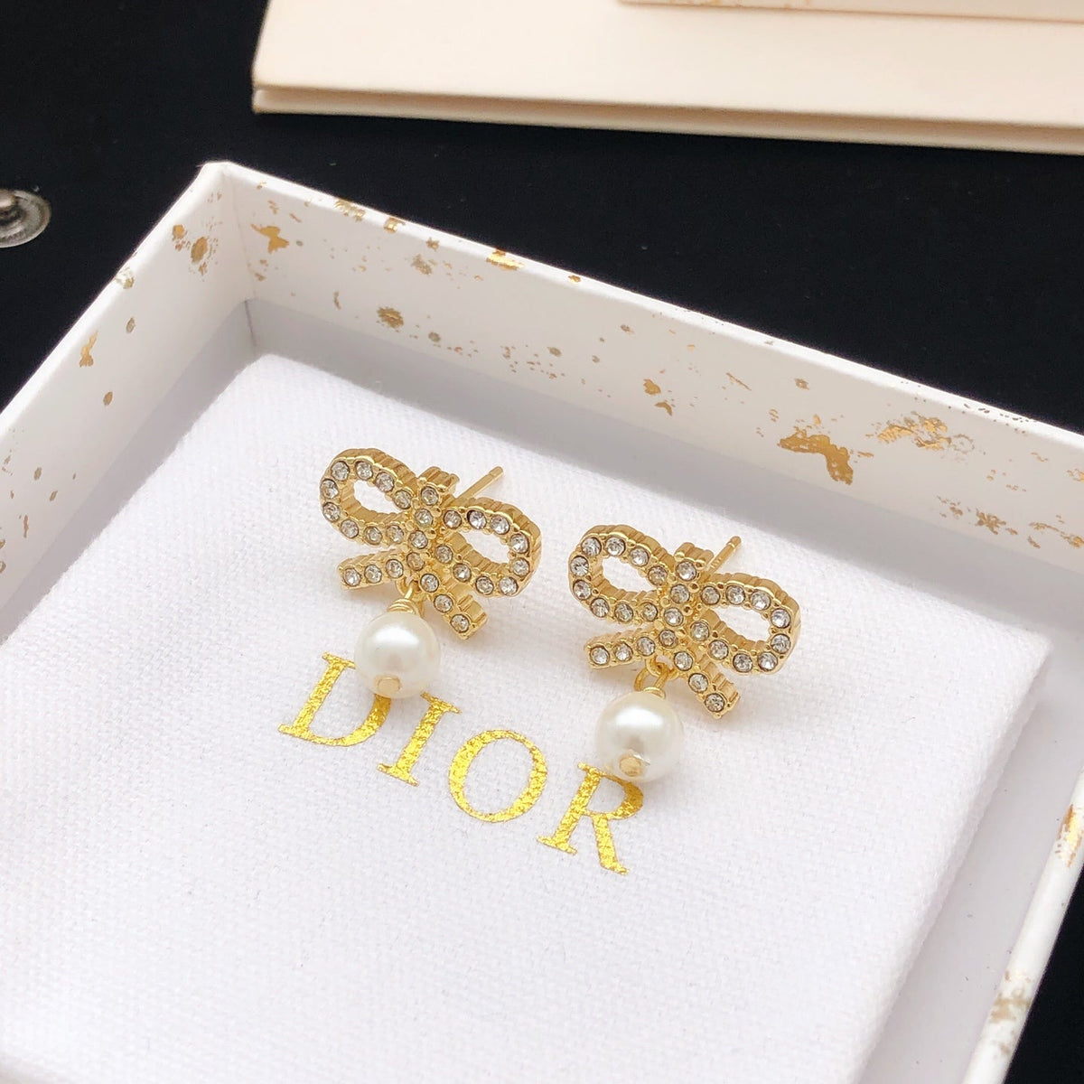 Martin Graham stud earrings in polished metal-tone – side detail
