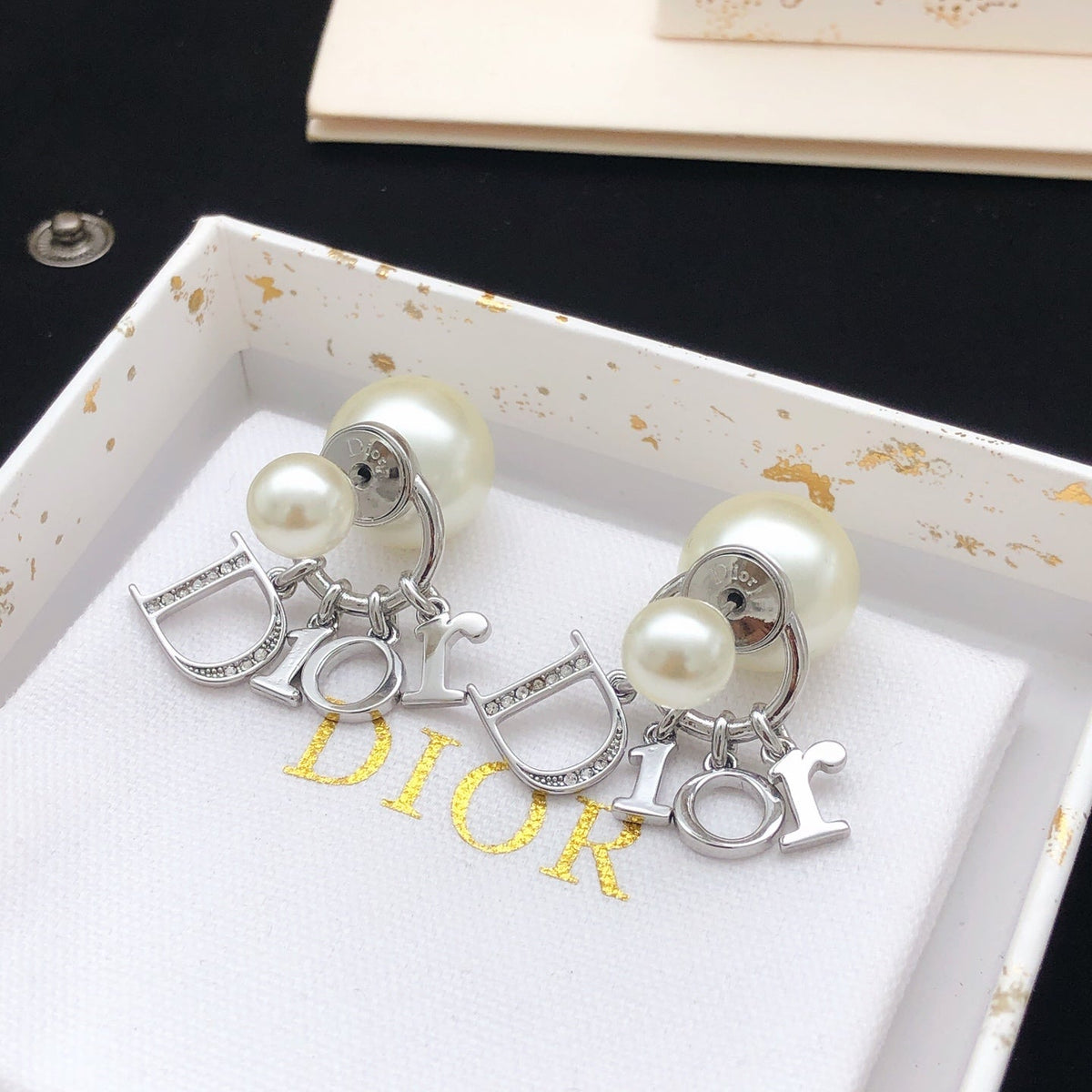 Martin Graham stud earrings in polished metal-tone – side detail