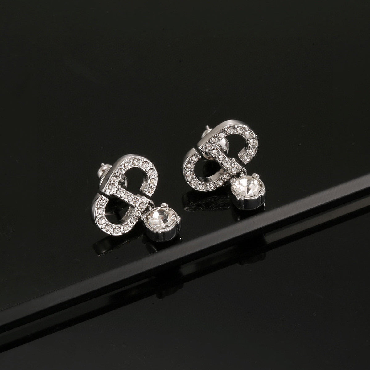 Martin Graham stud earrings in polished metal-tone – side detail
