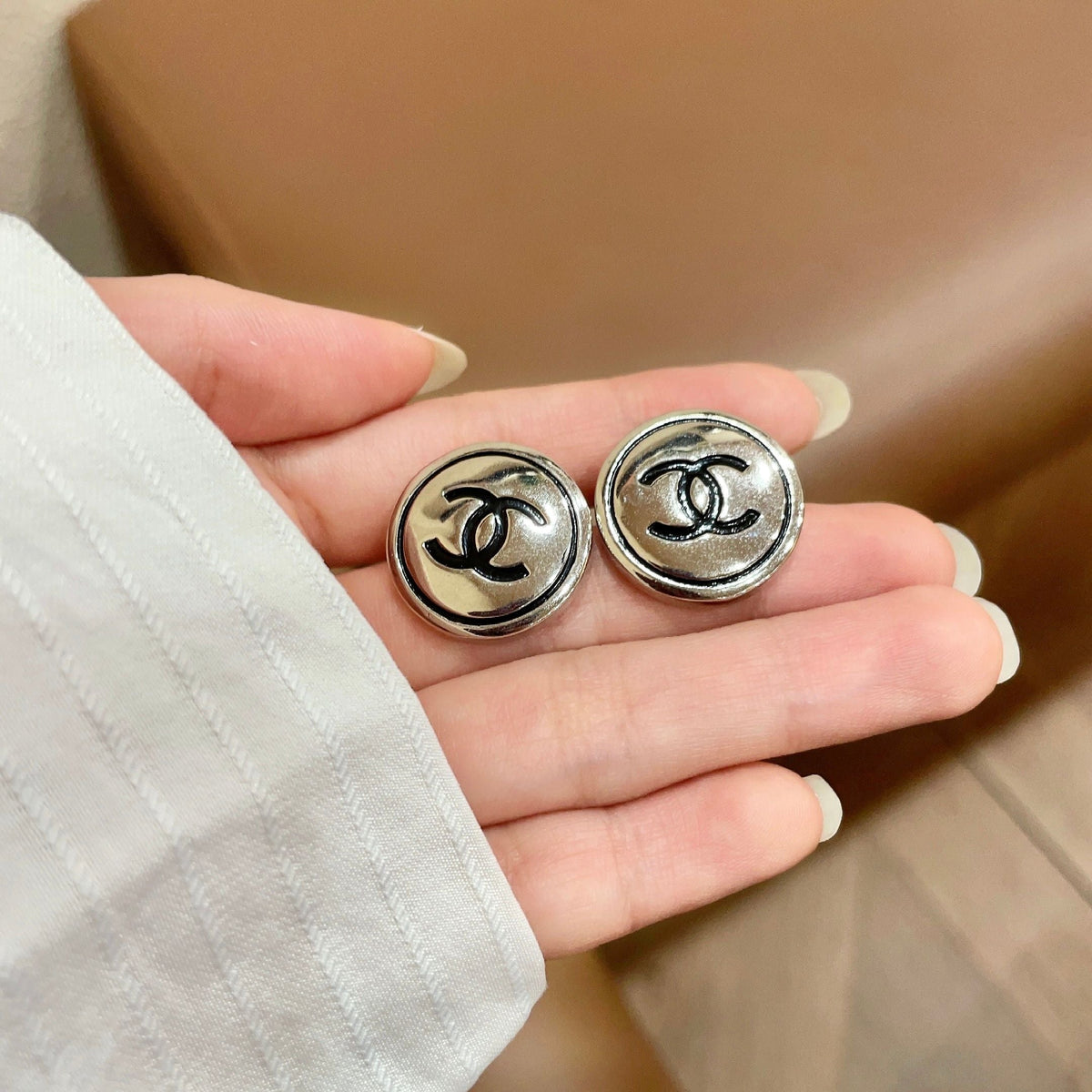Martin Graham stud earrings in polished metal-tone – side detail