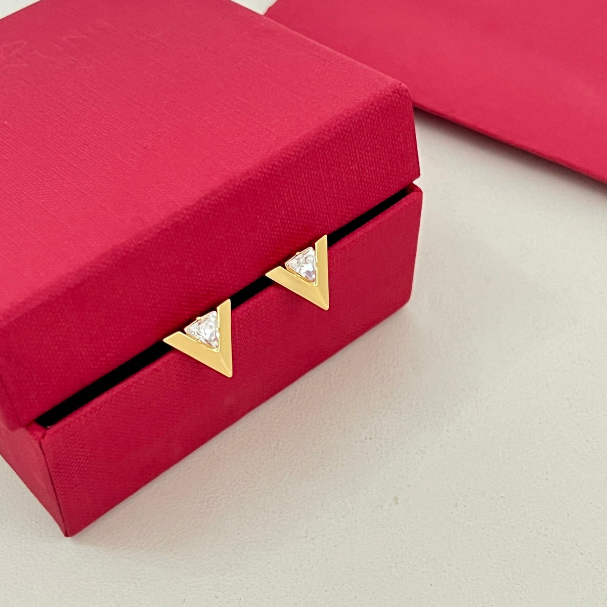 Martin Graham stud earrings in polished metal-tone – side detail