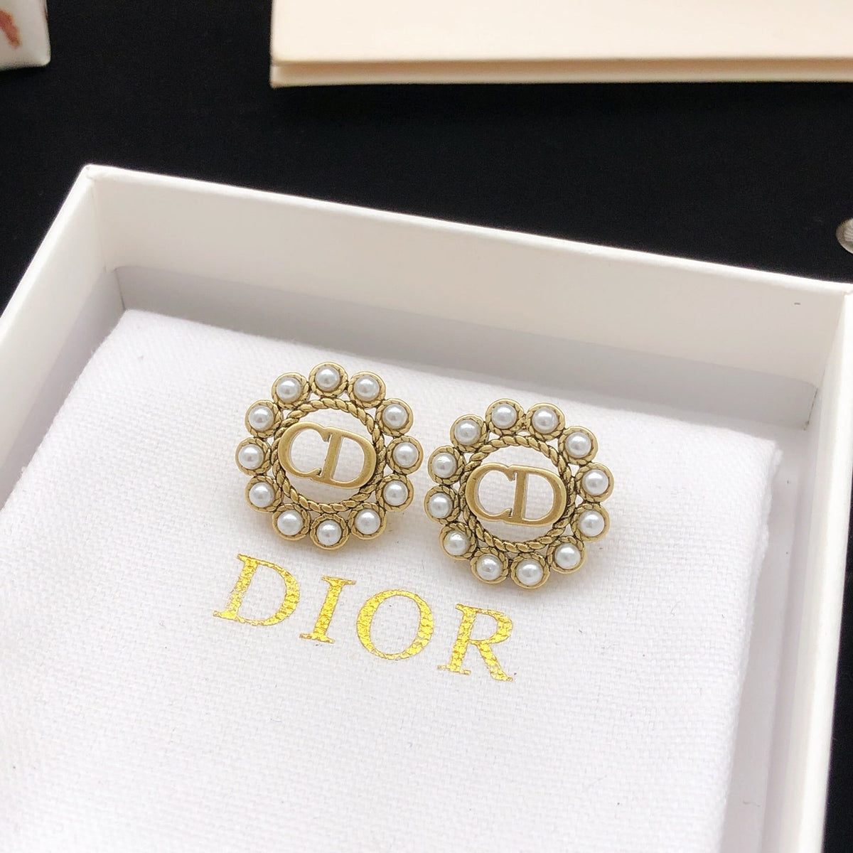 Martin Graham stud earrings in polished metal-tone – side detail