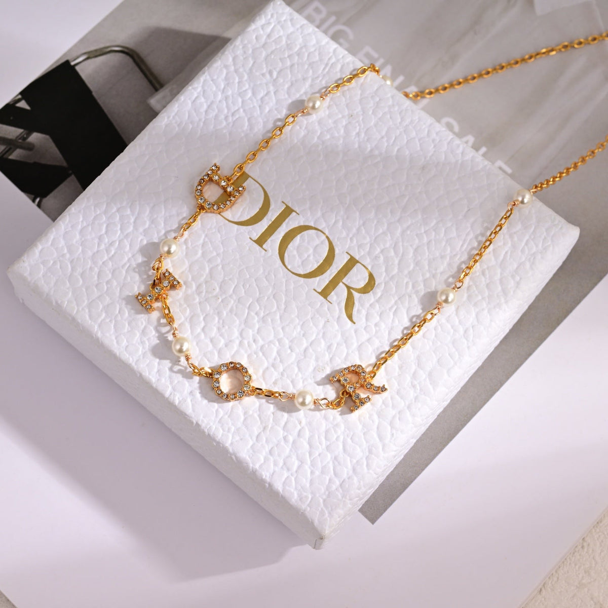 Martin Graham pendant necklace in polished metal-tone – side detail