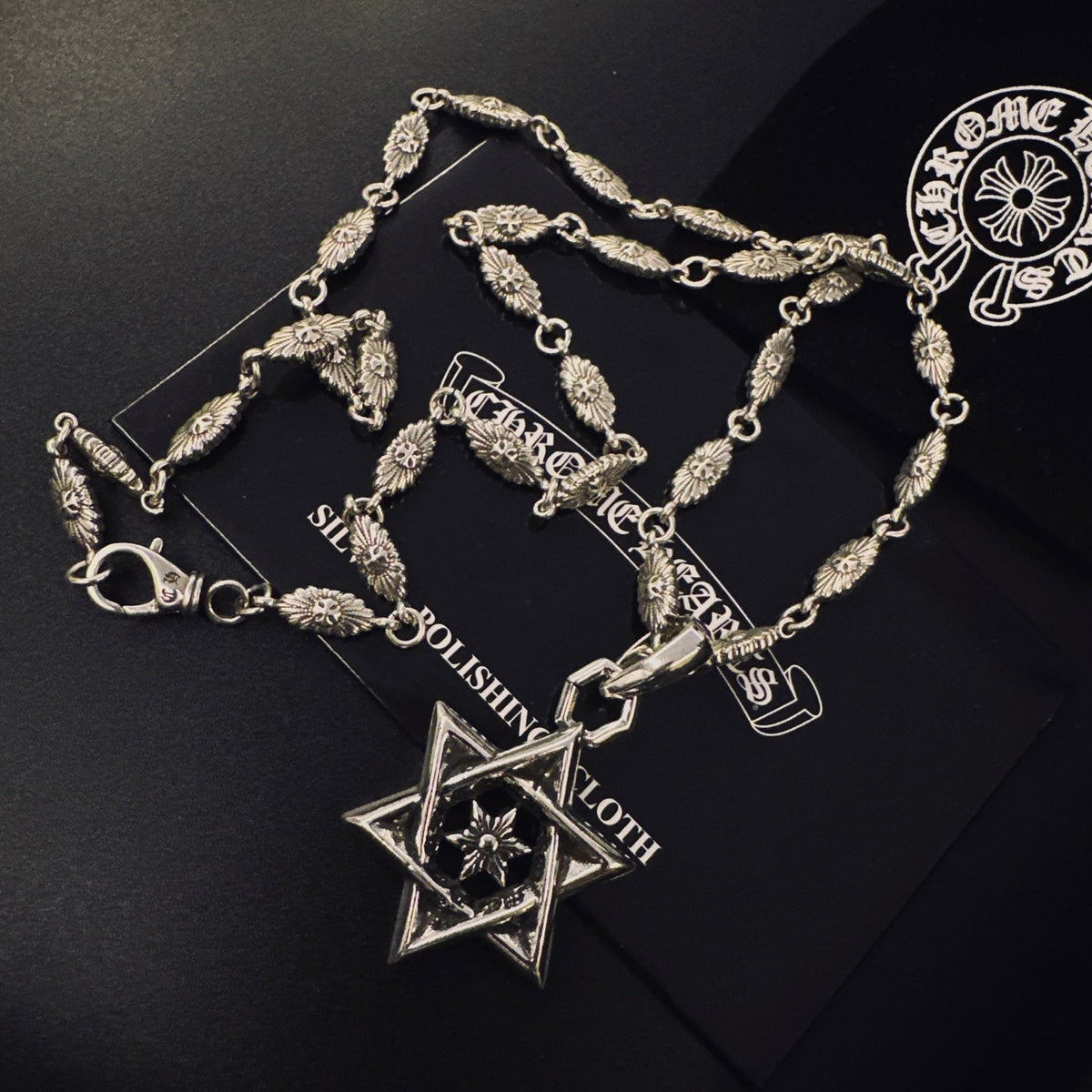Martin Graham pendant necklace in polished metal-tone – side detail