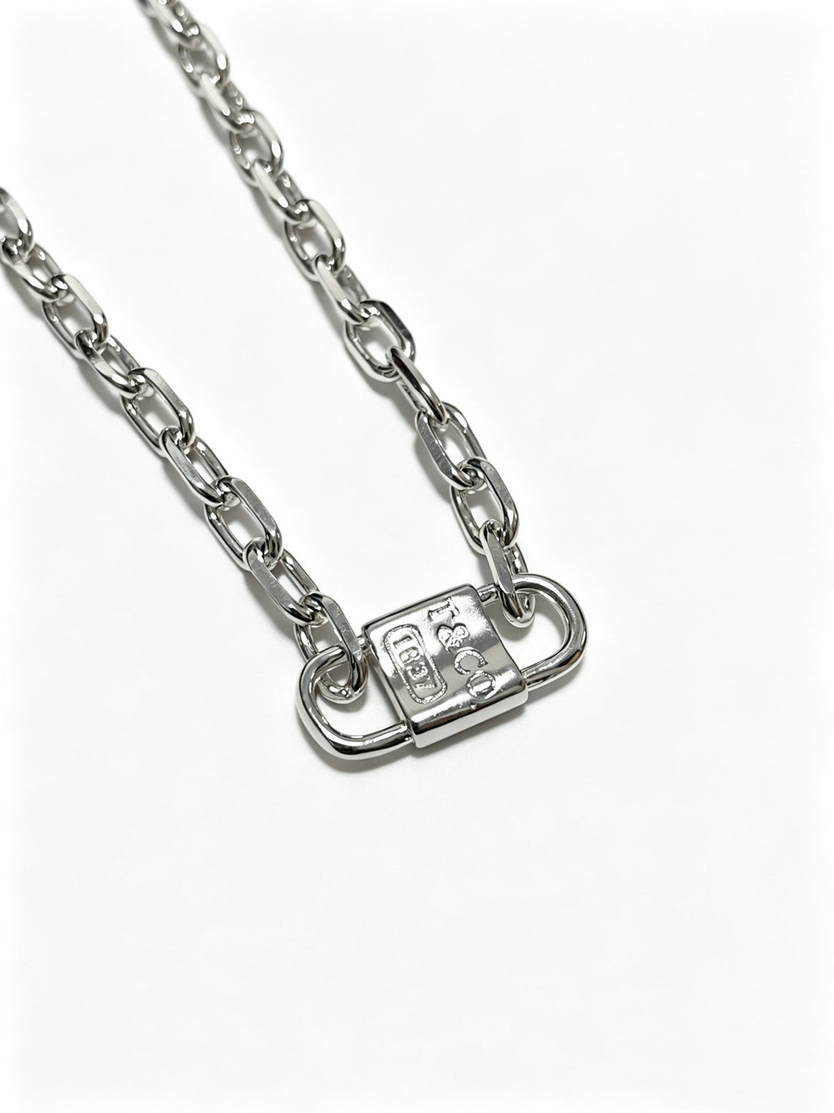 Martin Graham pendant necklace in polished metal-tone – side detail