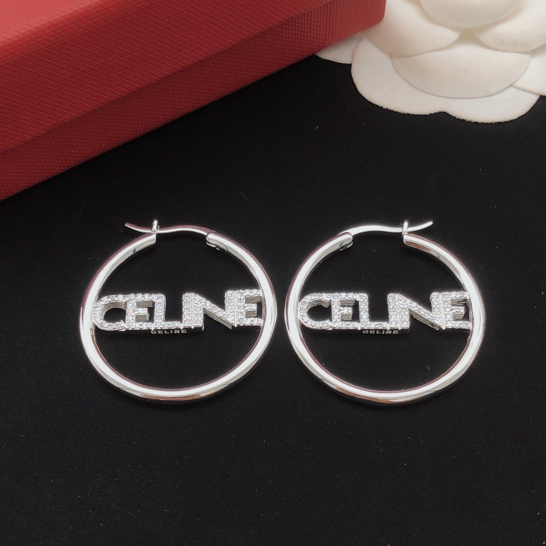 Martin Graham drop earrings in polished metal-tone – side detail